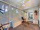 Screened-in sunroom with a ceiling fan, neutral carpet, and bench seating at 3078 Pointer Dr, Palm Harbor, FL 34683