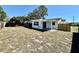 Spacious backyard featuring a covered patio, fenced perimeter, and ample space for outdoor activities and entertaining at 3111 Bigelow Dr, Holiday, FL 34691
