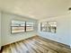 Bright bedroom with wood-look floors and two large windows that bring in plenty of natural light at 3111 Bigelow Dr, Holiday, FL 34691