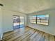 Sunroom with lots of natural light, wood-look floors, and sliding door access to the yard at 3111 Bigelow Dr, Holiday, FL 34691