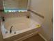 Bathroom features a soaking tub with decorative elements at 3132 Royal Tuscan Ln, Valrico, FL 33594