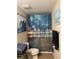 Cozy bathroom with toilet and decorative beach-themed shower curtain at 3132 Royal Tuscan Ln, Valrico, FL 33594