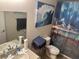 Cozy bathroom with a vanity sink, toilet, and decorative beach-themed shower curtain at 3132 Royal Tuscan Ln, Valrico, FL 33594