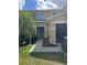 Inviting townhouse with a well-manicured lawn, mature landscaping, and an attached garage at 3132 Royal Tuscan Ln, Valrico, FL 33594
