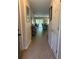 Long hallway with modern tile floors leading into an open living area, enhancing the sense of space at 3132 Royal Tuscan Ln, Valrico, FL 33594