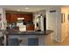 Open kitchen featuring stainless steel appliances, tile flooring, ample cabinet space, and a breakfast bar at 3132 Royal Tuscan Ln, Valrico, FL 33594