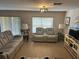 Cozy living room featuring neutral tones, recessed lighting, and comfortable seating; window provides natural light at 3132 Royal Tuscan Ln, Valrico, FL 33594