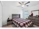 Comfortable bedroom featuring a ceiling fan, closet, and modern wood furniture at 35029 Brackett Bnd, Zephyrhills, FL 33541