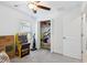 Bedroom showcasing open closet space, Pac-Personal game, neutral carpet and an inviting layout at 35029 Brackett Bnd, Zephyrhills, FL 33541