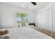 Inviting bedroom with a large window, closet, and soft, neutral tones, creating a tranquil atmosphere at 35029 Brackett Bnd, Zephyrhills, FL 33541