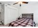 A cozy bedroom with a ceiling fan, carpet, and a spacious closet at 35029 Brackett Bnd, Zephyrhills, FL 33541