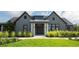 Exterior of a modern clubhouse with well-manicured landscaping and a covered entrance at 35029 Brackett Bnd, Zephyrhills, FL 33541