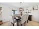 Dining room with modern chandelier and decorative wall shelves at 35029 Brackett Bnd, Zephyrhills, FL 33541
