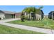 Manicured lawn and landscaping enhances curb appeal at 35029 Brackett Bnd, Zephyrhills, FL 33541