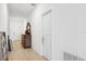 Bright hallway with tile flooring, neutral walls, and antique furniture for a welcoming ambiance at 35029 Brackett Bnd, Zephyrhills, FL 33541