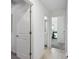 Bright hallway featuring tile flooring and white doors leading to bedrooms and bathrooms at 35029 Brackett Bnd, Zephyrhills, FL 33541