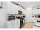 Kitchen features stainless steel appliances, sleek countertops, and ample white cabinetry at 35029 Brackett Bnd, Zephyrhills, FL 33541