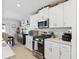 Modern kitchen features white cabinets, stainless steel appliances, and granite counters at 35029 Brackett Bnd, Zephyrhills, FL 33541