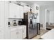 Kitchen area featuring stainless steel refrigerator, appliances, and white cabinets at 35029 Brackett Bnd, Zephyrhills, FL 33541