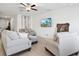 Open-concept living room features tile floors, comfortable seating, and a modern aesthetic at 35029 Brackett Bnd, Zephyrhills, FL 33541