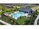 Community pool and lounge area with manicured landscaping, seating, and cornhole game at 35029 Brackett Bnd, Zephyrhills, FL 33541