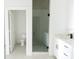 Clean bathroom with white cabinets, modern fixtures, and a glass-enclosed shower at 3820 Pompano Se Dr, St Petersburg, FL 33705