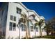 Modern multi-story building featuring light blue siding, white trim, and well-maintained landscaping at 3820 Pompano Se Dr, St Petersburg, FL 33705
