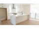 New kitchen boasting white cabinets, quartz countertops, island with sink, and stainless steel appliances at 3820 Pompano Se Dr, St Petersburg, FL 33705