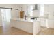Stylish kitchen with an island, white cabinets, quartz countertops, and stainless steel appliances at 3820 Pompano Se Dr, St Petersburg, FL 33705