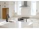 Close-up of the modern kitchen featuring white cabinets, quartz countertops, and stainless steel range at 3820 Pompano Se Dr, St Petersburg, FL 33705