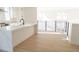 Contemporary open kitchen with quartz island, modern appliances, and adjacent railing overlooking the living area at 3820 Pompano Se Dr, St Petersburg, FL 33705