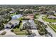 Aerial view of the property showcasing lush landscaping, a pond, and surrounding neighborhood at 3982 Wellington Pkwy, Palm Harbor, FL 34685