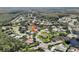 Aerial view showing neighborhood with mature trees, ponds, and nearby amenities at 3982 Wellington Pkwy, Palm Harbor, FL 34685