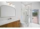 Stylish bathroom with wood vanity, marble countertop, and a glass-enclosed shower next to pool access at 3982 Wellington Pkwy, Palm Harbor, FL 34685
