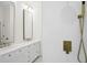 Modern bathroom with double vanity, elegant fixtures, and a tiled shower at 3982 Wellington Pkwy, Palm Harbor, FL 34685