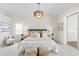Bright main bedroom with sliding doors leading to covered lanai, neutral colors, and carpet at 3982 Wellington Pkwy, Palm Harbor, FL 34685