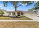 Beautiful single-story home with mature landscaping and a three-car garage at 3982 Wellington Pkwy, Palm Harbor, FL 34685