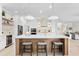 Bright, open kitchen with marble countertops, stainless appliances, and pendant lighting over island at 3982 Wellington Pkwy, Palm Harbor, FL 34685