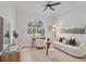 Bright living room with neutral colors, a large arched window, and modern decor at 3982 Wellington Pkwy, Palm Harbor, FL 34685