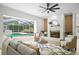 Elegant living room with a fireplace and an open view of the refreshing screened-in pool area at 3982 Wellington Pkwy, Palm Harbor, FL 34685