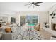 Bright living room with brick fireplace and a view of the screened-in pool at 3982 Wellington Pkwy, Palm Harbor, FL 34685