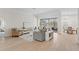 Spacious living room with neutral tones, wood floors, modern decor, and view of pool at 3982 Wellington Pkwy, Palm Harbor, FL 34685