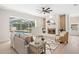 Cozy living room boasts a white brick fireplace and an inviting view of the screened-in pool at 3982 Wellington Pkwy, Palm Harbor, FL 34685