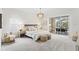 Calming main bedroom with plush carpeting, neutral tones, and sliding glass doors leading to an outdoor dining area at 3982 Wellington Pkwy, Palm Harbor, FL 34685