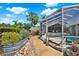 Landscaped backyard area with screened in porch, small pool and patio area at 4101 Hollowtrail Dr, Tampa, FL 33624