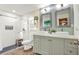 Modern bathroom with a double vanity, two vessel sinks, and a glass-enclosed tiled shower at 4101 Hollowtrail Dr, Tampa, FL 33624