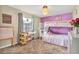 Bright bedroom featuring a unique light fixture and a charming bunk bed, creating a playful and inviting space at 4101 Hollowtrail Dr, Tampa, FL 33624