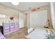 Bright bedroom with built-in shelving and drawers with tiled floors and access to an open closet at 4101 Hollowtrail Dr, Tampa, FL 33624