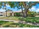 This property features stone accents, a sprawling lawn, and mature trees, offering a serene and private setting at 4101 Hollowtrail Dr, Tampa, FL 33624
