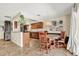 Kitchen and dining area featuring wood cabinets, tile floors, modern appliances, and a round dining table at 4101 Hollowtrail Dr, Tampa, FL 33624